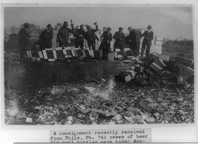 Men destroying cases of beer in Washington, D.C., November 20, 1923.